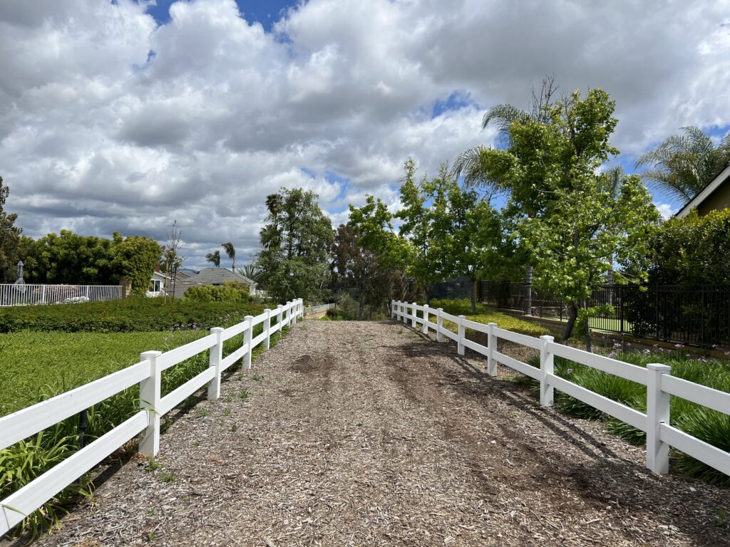 White fence on a rocky road